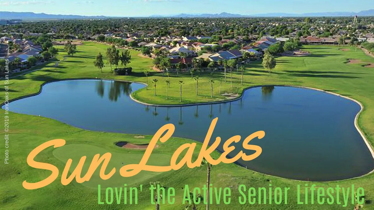 A picturesque lake sits at the heart of a lush green landscape, bordered by palm trees and residential homes. The view is relaxing and inviting, with the possibility of leisurely walks, community picnics, or simply unwinding by the water—all set against the backdrop of Arizona’s natural beauty.